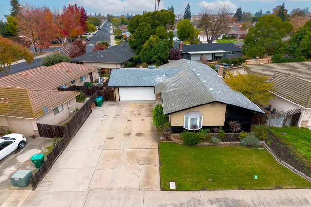 an aerial view of a house with swimming pool outdoor seating and yard