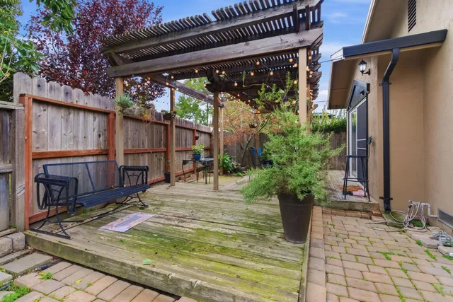 a front view of a house with a yard and potted plants