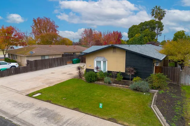 an aerial view of a house with a yard
