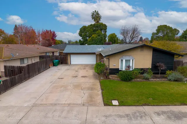 an aerial view of a house with a yard