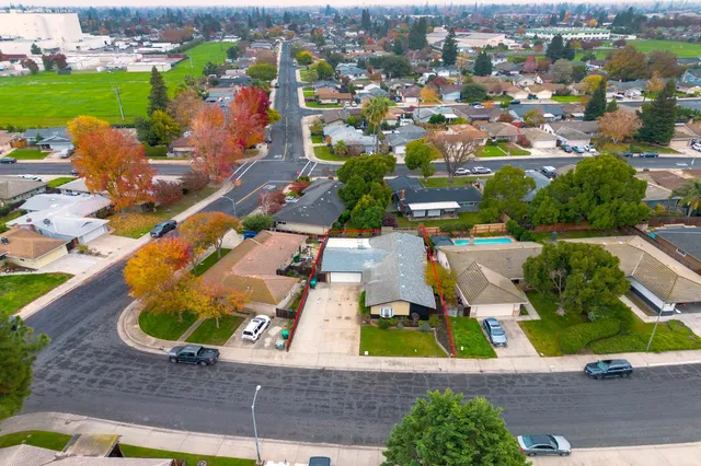 an aerial view of residential houses with outdoor space