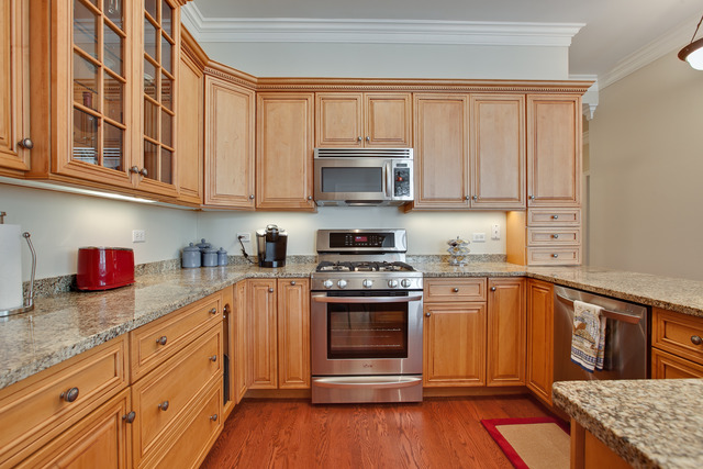 502 South Commons Court, Unit 502 Deerfield, IL 60015 - Photo 11 of 33 a kitchen with stainless steel appliances granite countertop a stove a sink and a microwave