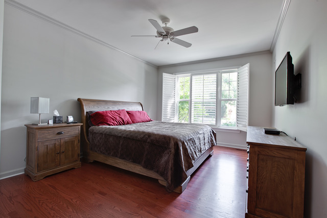 502 South Commons Court, Unit 502 Deerfield, IL 60015 - Photo 13 of 33 a spacious bedroom with a bed and a flat screen tv
