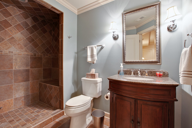 502 South Commons Court, Unit 502 Deerfield, IL 60015 - Photo 21 of 33 a bathroom with a toilet a sink and a mirror