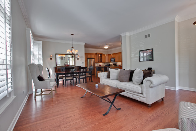 502 South Commons Court, Unit 502 Deerfield, IL 60015 - Photo 4 of 33 a living room with furniture and a dining table with wooden floor