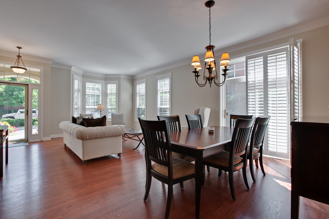 502 South Commons Court, Unit 502 Deerfield, IL 60015 - Photo 6 of 33 a dining room with furniture a chandelier and wooden floor