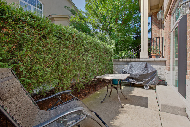 502 South Commons Court, Unit 502 Deerfield, IL 60015 - Photo 9 of 33 a view of a patio with table and chairs with barbeque grill and plants