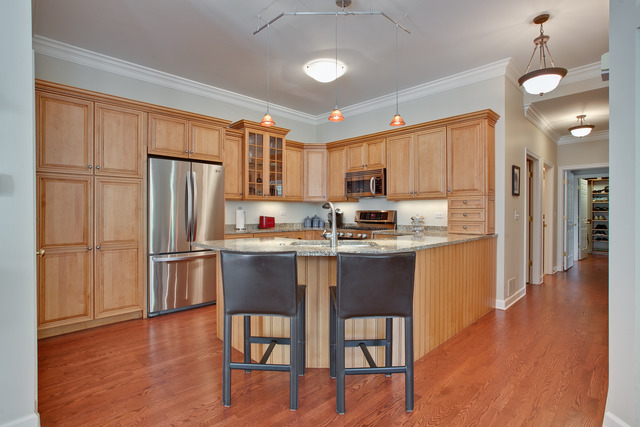 502 South Commons Court, Unit 502 Deerfield, IL 60015 - Photo 10 of 33 a kitchen with stainless steel appliances granite countertop a refrigerator a stove a sink dishwasher and a refrigerator with wooden floor