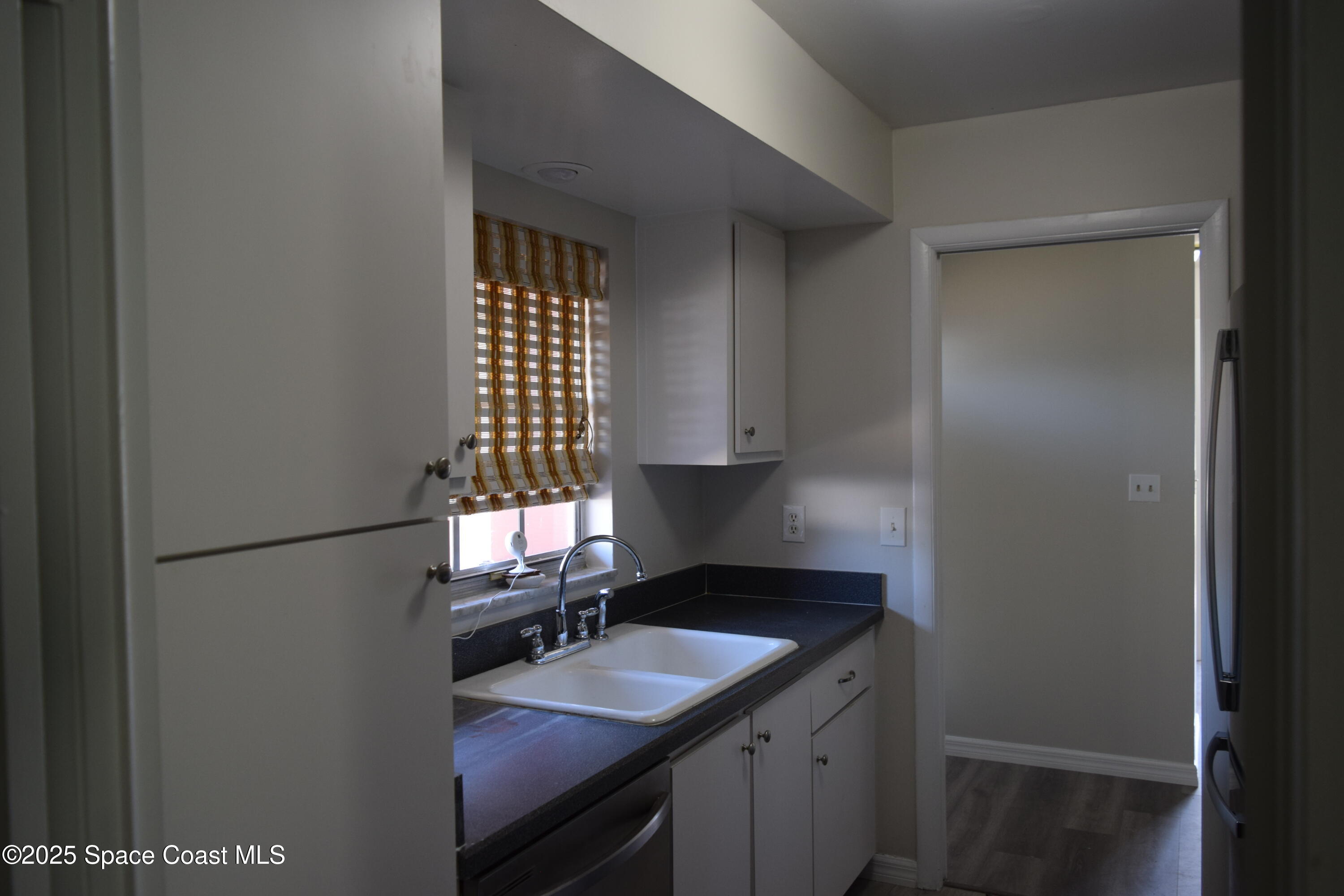 2696 Yalta Street Northeast Palm Bay, FL 32905 - Photo 12 of 28 a kitchen with a sink cabinets and a window