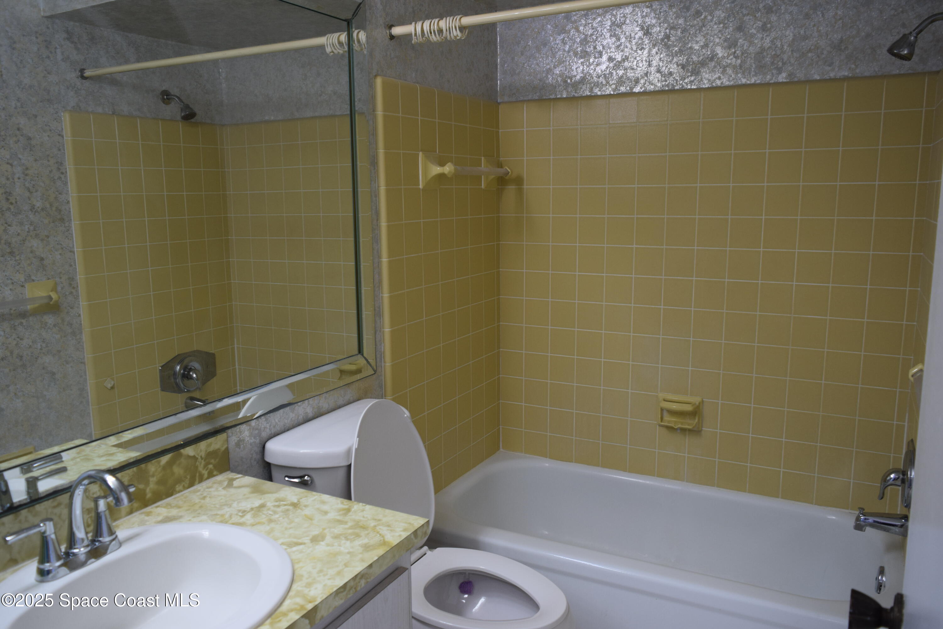 2696 Yalta Street Northeast Palm Bay, FL 32905 - Photo 20 of 28 a bathroom with a granite countertop bathtub shower sink vanity and toilet