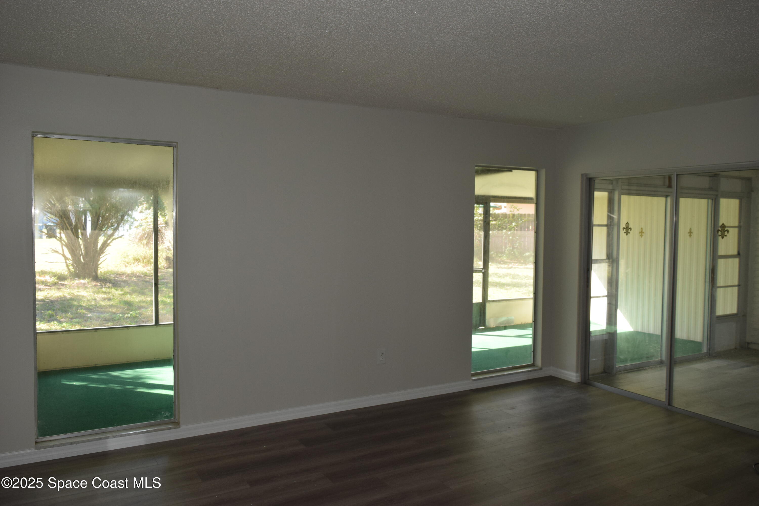 2696 Yalta Street Northeast Palm Bay, FL 32905 - Photo 4 of 28 wooden floor in an empty room with a window