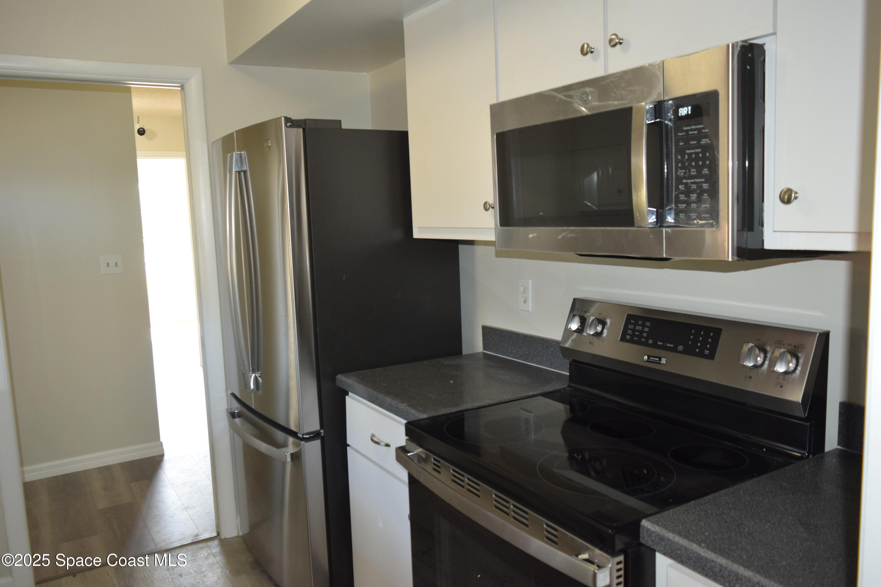 2696 Yalta Street Northeast Palm Bay, FL 32905 - Photo 10 of 28 a kitchen with stainless steel appliances granite countertop a refrigerator and a stove