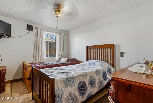 a bedroom with bed and dresser