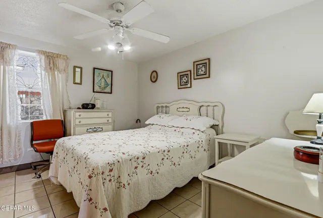 a bedroom with a bed and dresser with mirror