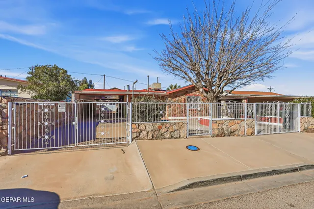a view of a dining room with furniture and a chandelier