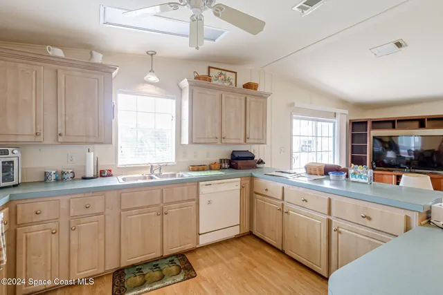 a kitchen with sink stove and cabinets