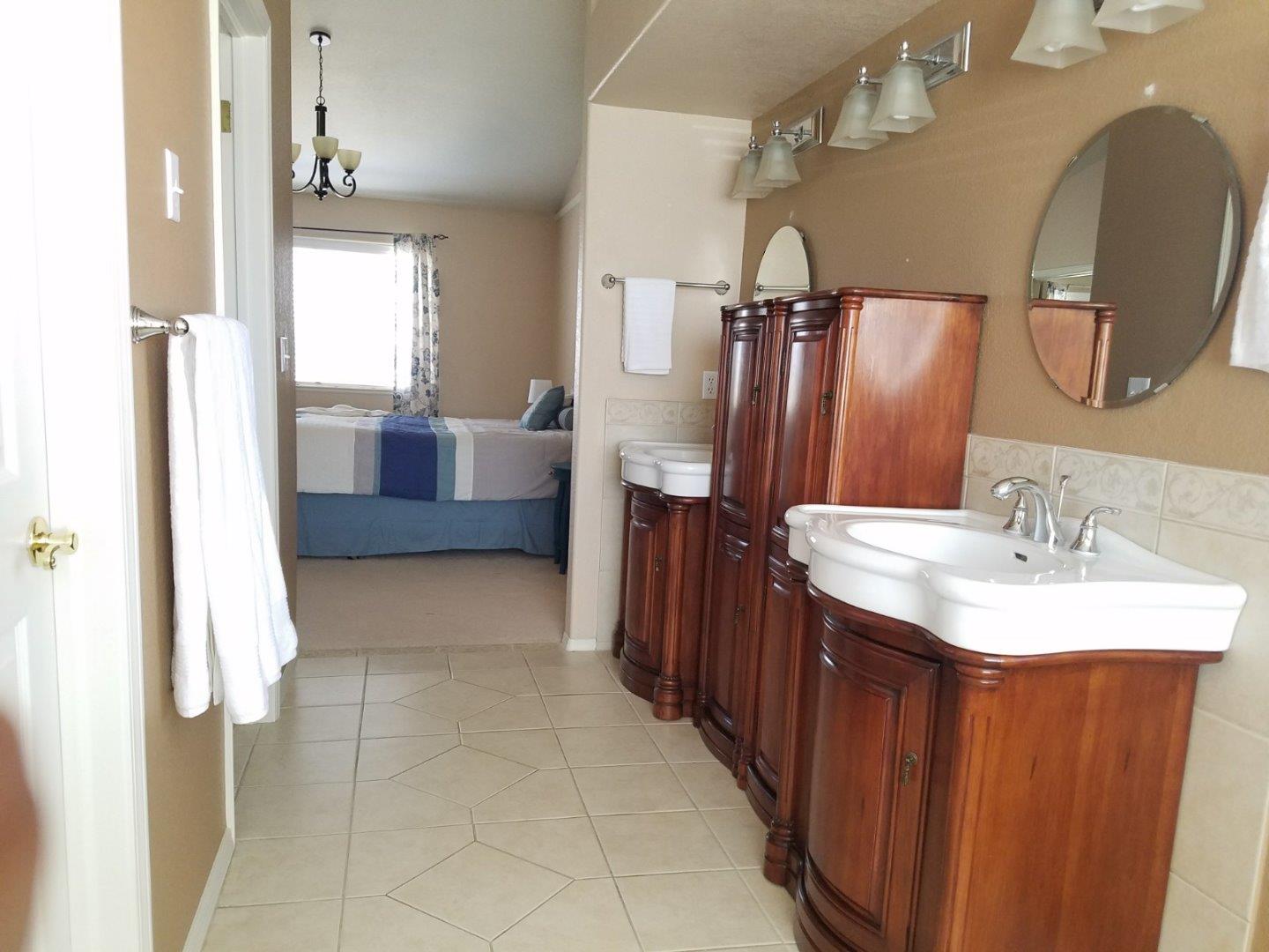 148 Greenbriar Way Salinas, CA 93907 - Photo 21 of 29 a en suite bathroom with a double vanity sink and a mirror
