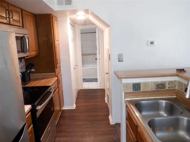 a kitchen with a refrigerator and a sink
