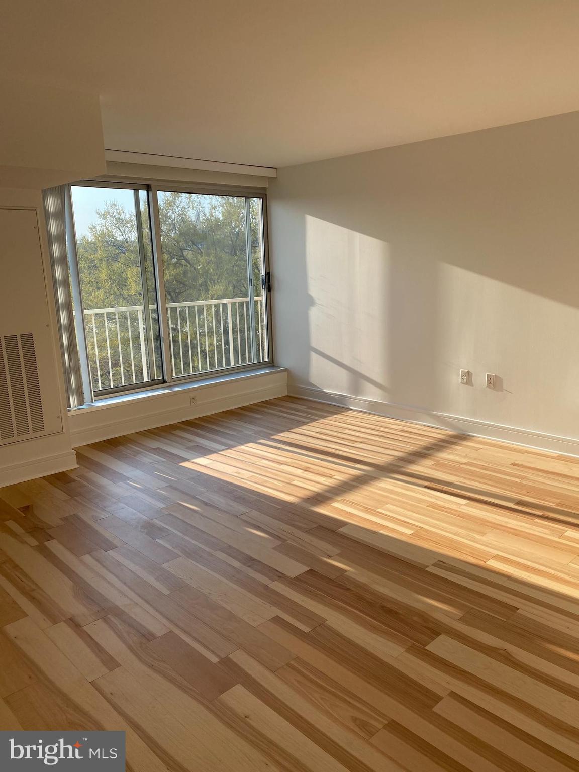 800 4th Street Southwest, Unit S621 Washington, DC 20024 - Photo 4 of 15 a view of an empty room with wooden floor and a window