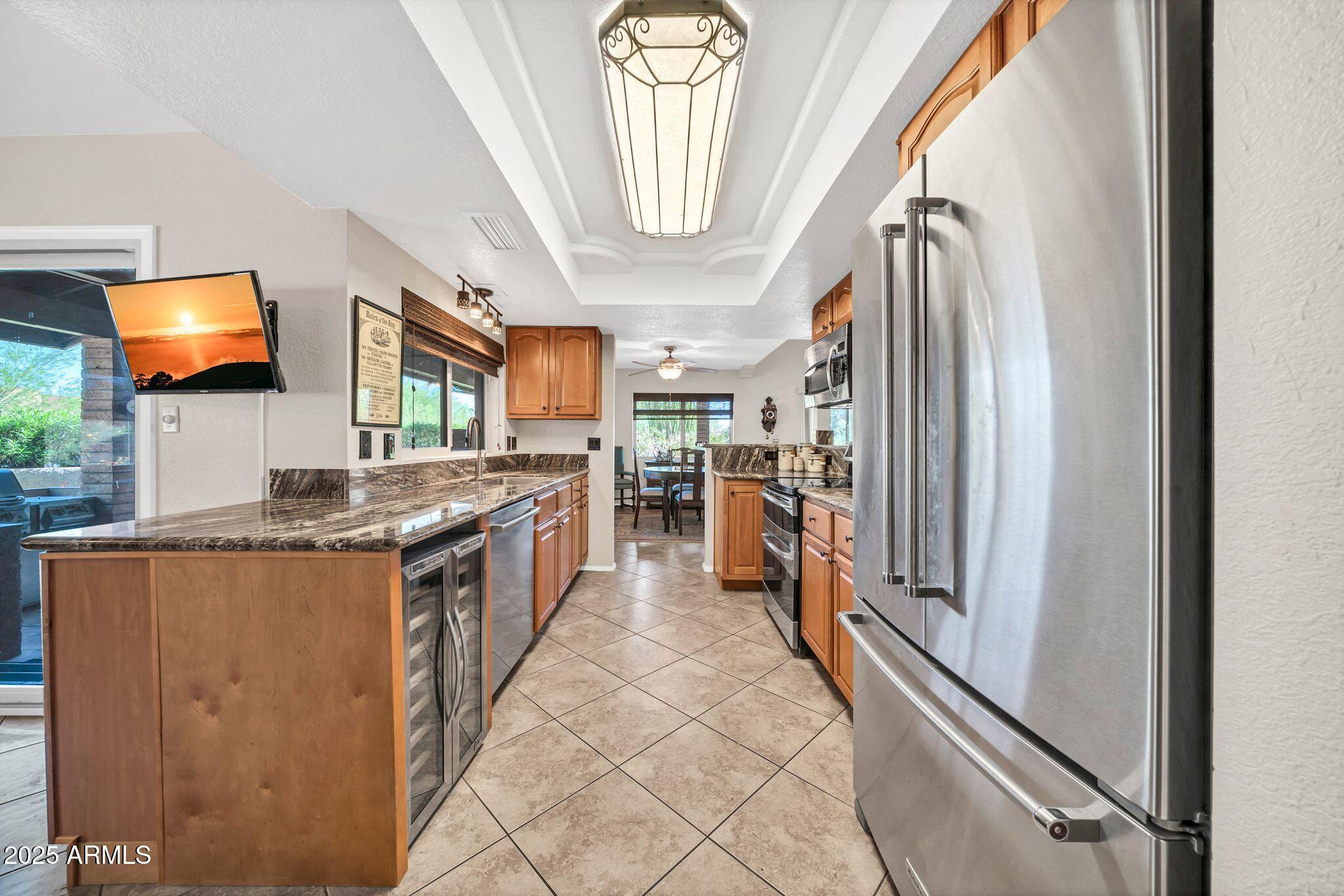 25621 Cordova Lane Rio Verde, AZ 85263 - Photo 15 of 42 a kitchen with stainless steel appliances granite countertop a refrigerator a stove and a sink