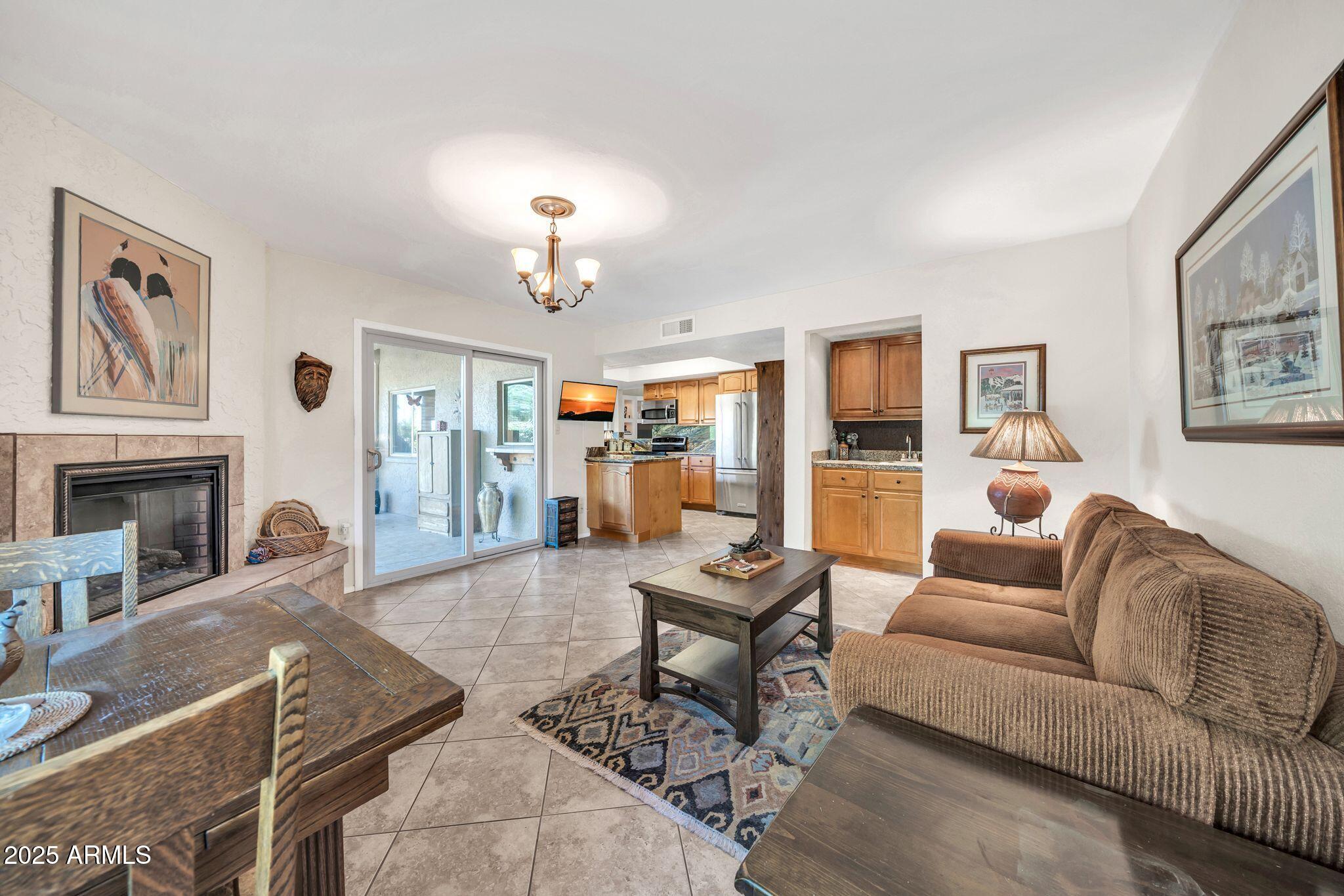 25621 Cordova Lane Rio Verde, AZ 85263 - Photo 16 of 42 a living room with furniture a fireplace and a chandelier