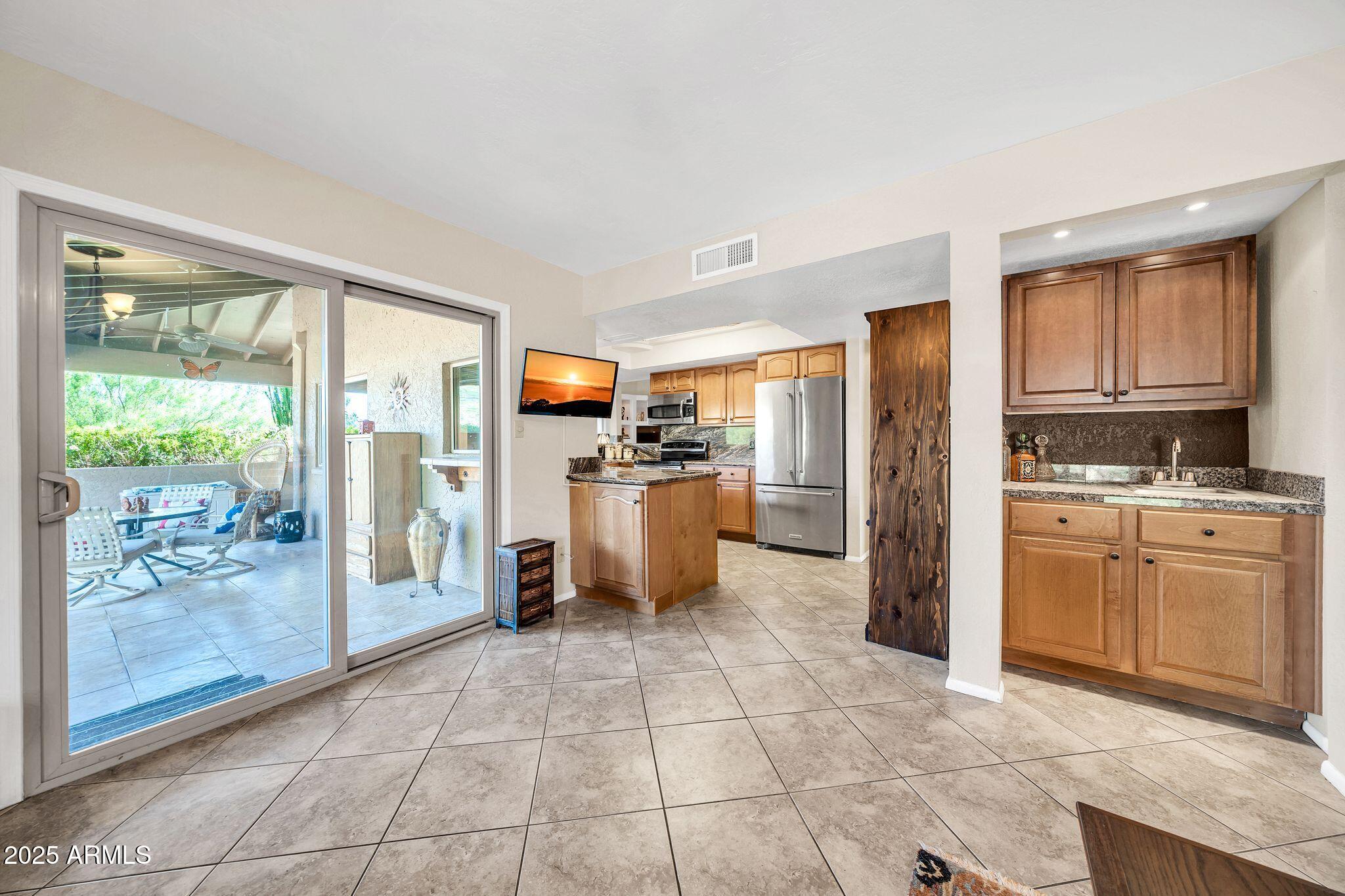 25621 Cordova Lane Rio Verde, AZ 85263 - Photo 17 of 42 a kitchen with stainless steel appliances granite countertop a refrigerator and cabinets