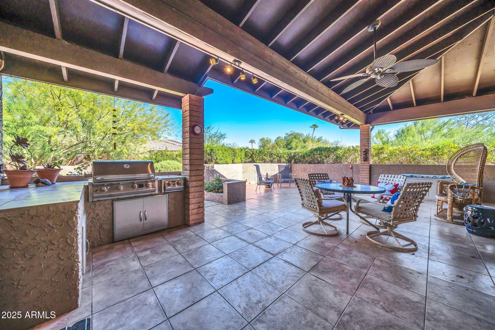 25621 Cordova Lane Rio Verde, AZ 85263 - Photo 2 of 42 a view of a patio with a table chairs and a backyard