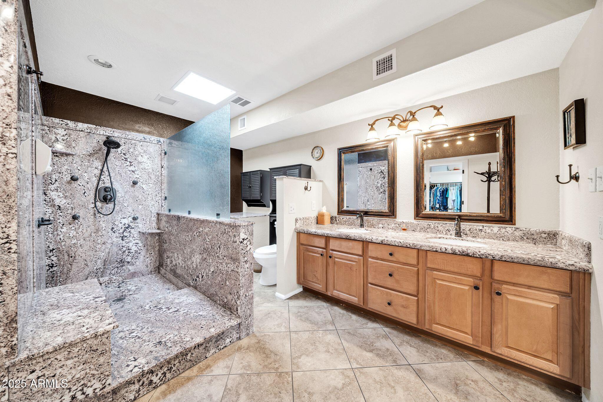 25621 Cordova Lane Rio Verde, AZ 85263 - Photo 25 of 42 a spacious bathroom with a granite countertop sink mirror and shower