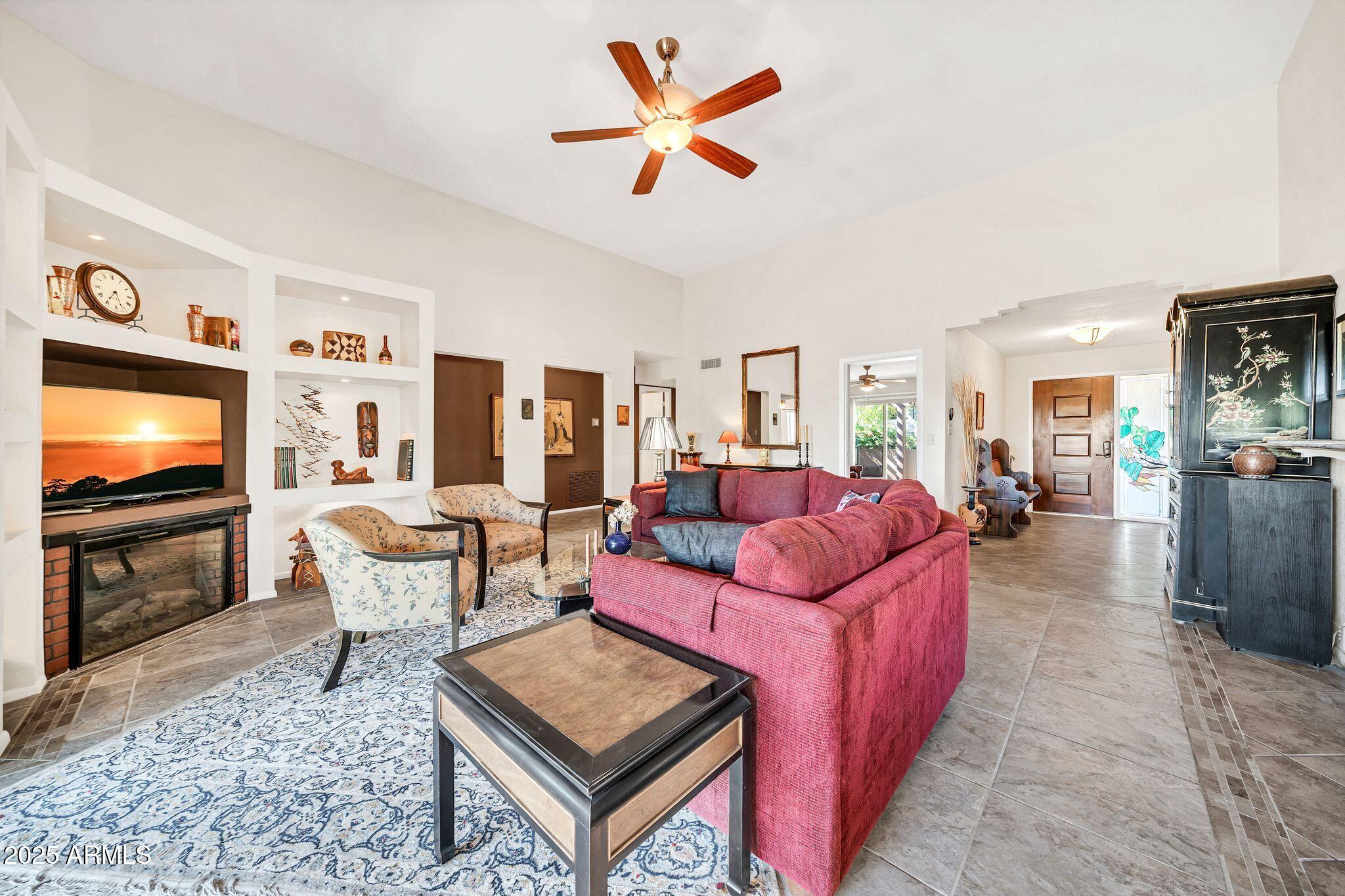 25621 Cordova Lane Rio Verde, AZ 85263 - Photo 9 of 42 a living room with furniture a flat screen tv and kitchen view