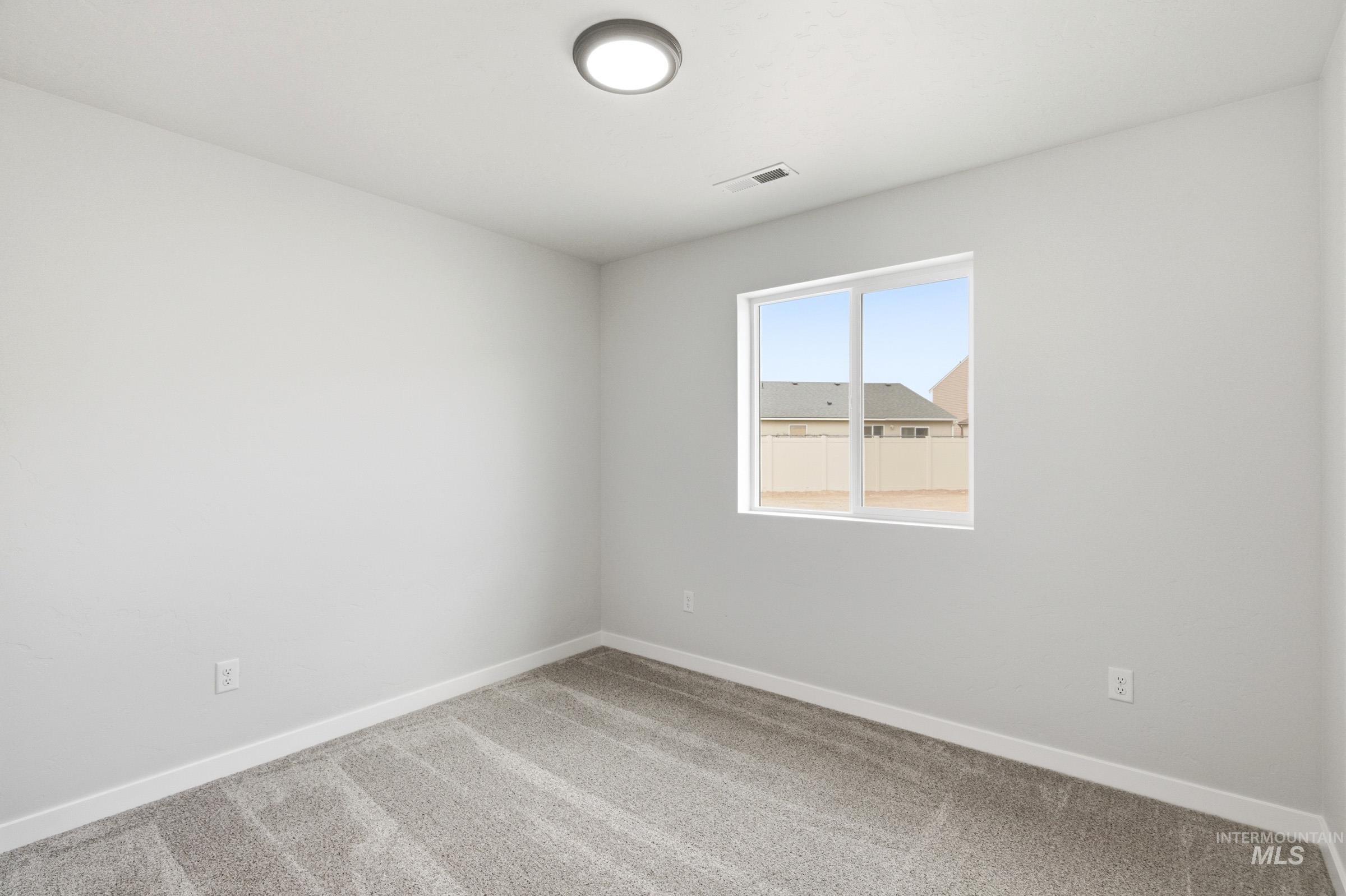 13735 Inman Court Caldwell, ID 83607 - Photo 12 of 20 Spare room with baseboards and light carpet