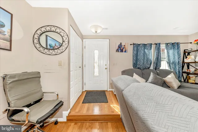 a living room with furniture and a mirror