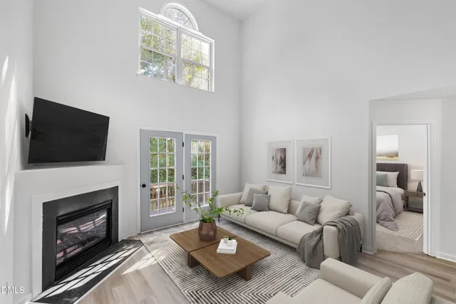 a living room with furniture a fireplace and a flat screen tv