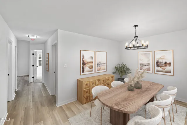 a view of a dining room with furniture wooden floor and a chandelier