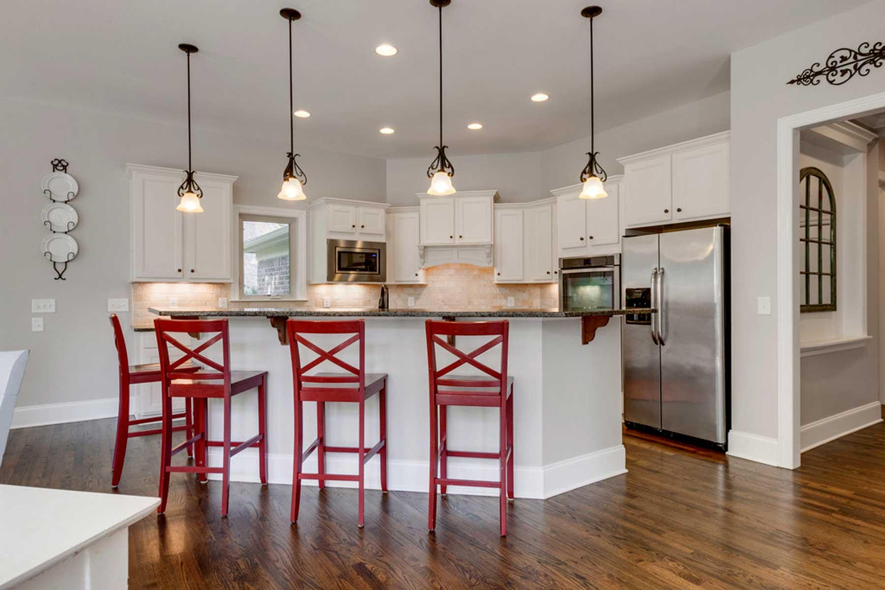 3421 Herbert Drive Franklin, TN 37067 - Photo 16 of 30 a kitchen with stainless steel appliances a dining table chairs a sink and wooden floor