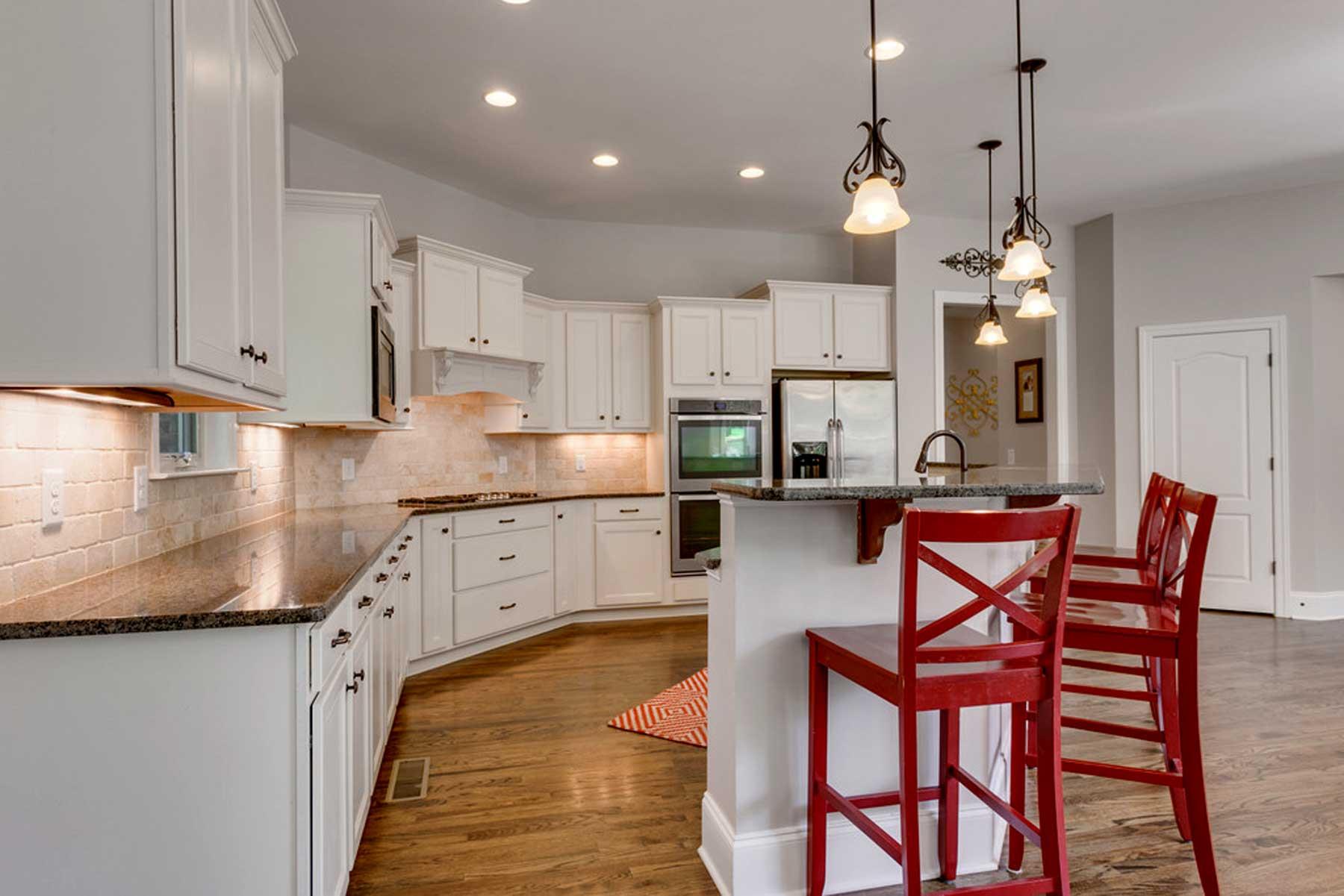3421 Herbert Drive Franklin, TN 37067 - Photo 17 of 30 a kitchen with stainless steel appliances granite countertop a kitchen island a stove a sink dishwasher and white cabinets with wooden floor
