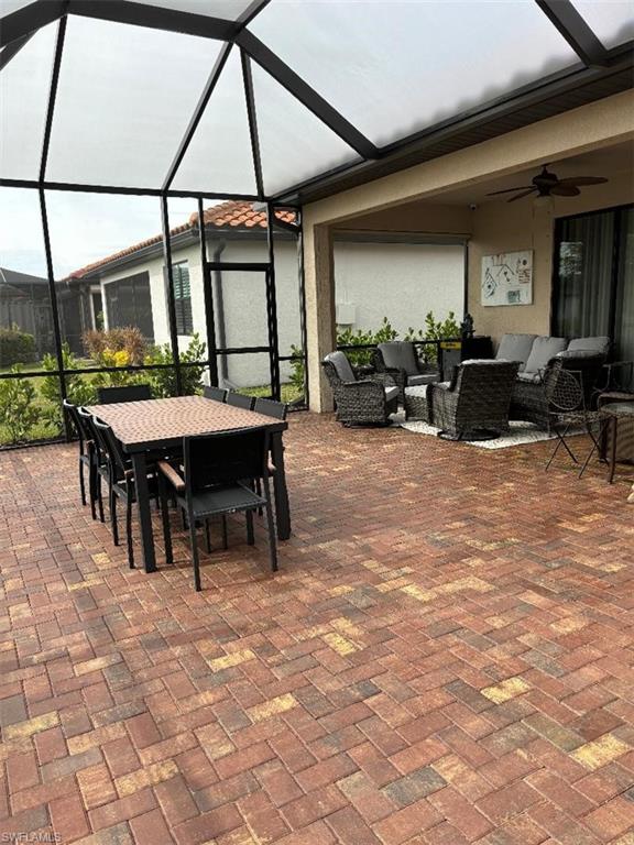 1599 Marton Court Naples, FL 34113 - Photo 21 of 22 a view of a patio with table and chairs under an umbrella