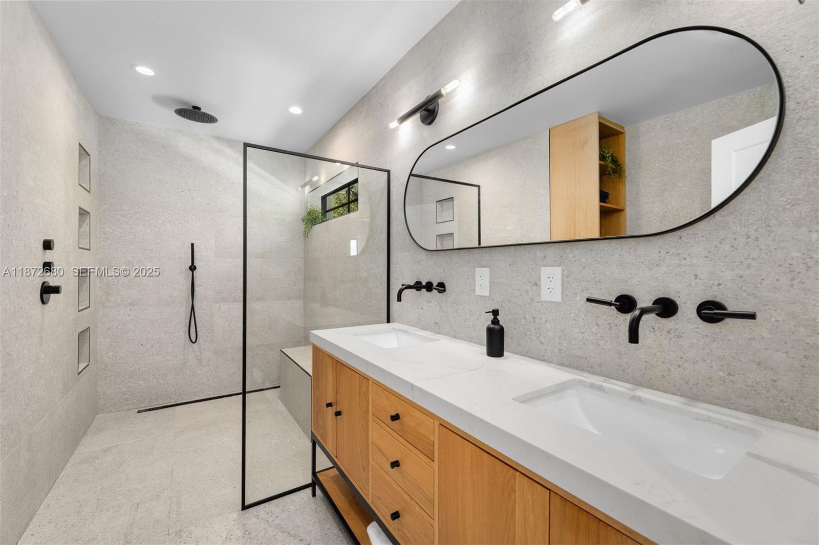 8934 Garland Avenue Surfside, FL 33154 - Photo 11 of 20 a bathroom with a sink and a mirror