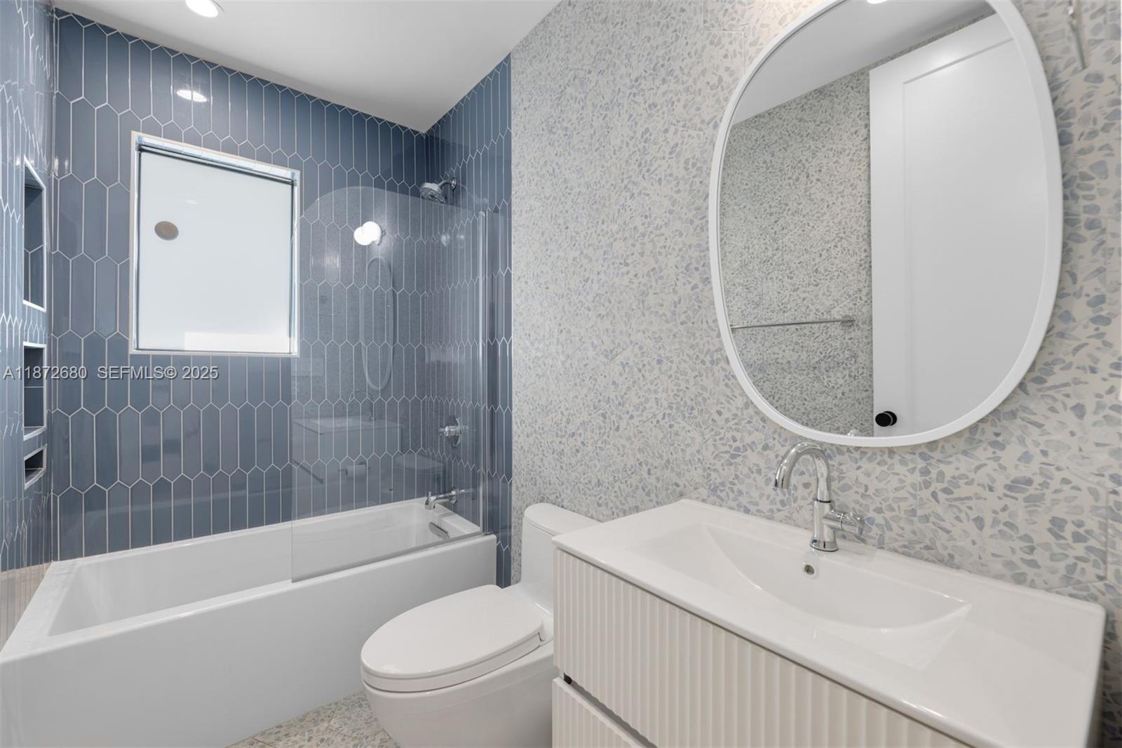 8934 Garland Avenue Surfside, FL 33154 - Photo 13 of 20 a bathroom with a sink a toilet and bathtub