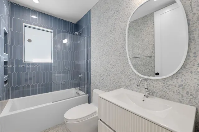 a bathroom with a sink a toilet and bathtub