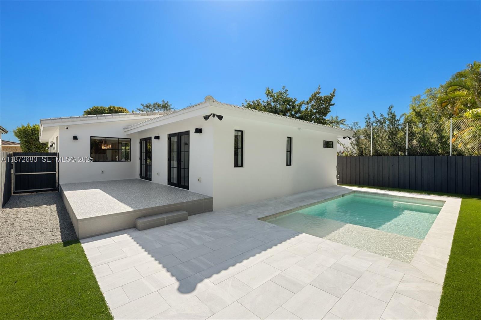 8934 Garland Avenue Surfside, FL 33154 - Photo 17 of 20 a view of a white house with a yard