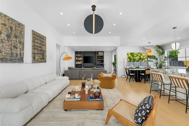 a living room with furniture and a chandelier