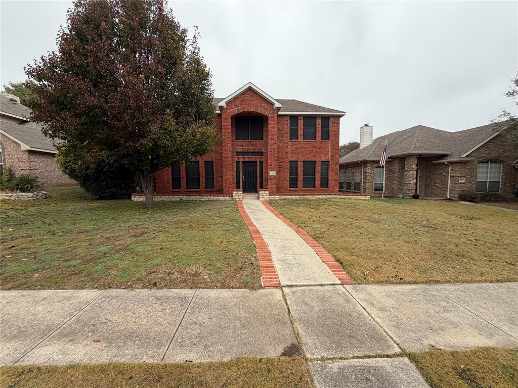 a front view of a house with a yard