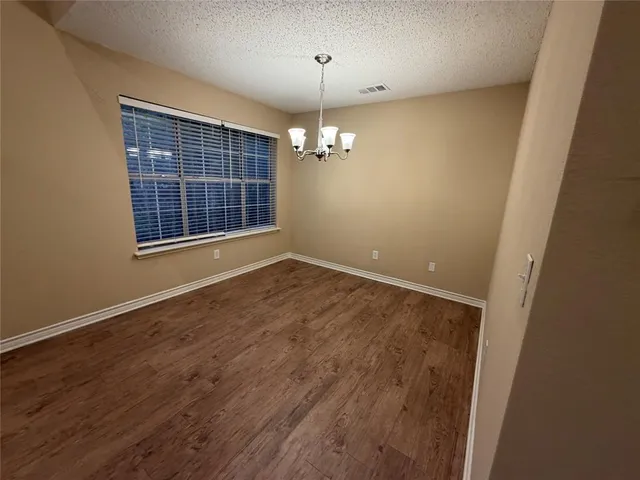 en empty room with windows and door