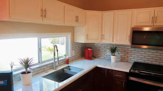 a kitchen with a sink and cabinets