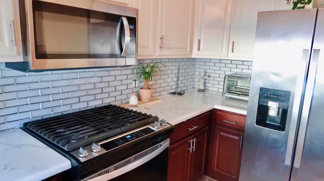 a kitchen with granite countertop a stove and a sink