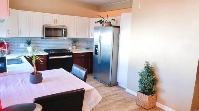 a kitchen with a table and chairs