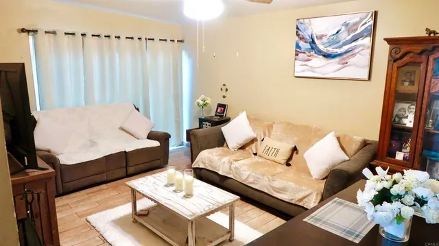 a living room with furniture and wooden floor