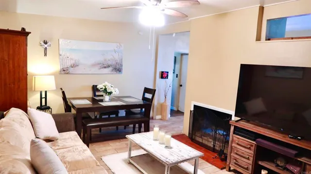 a living room with furniture a piano and a flat screen tv