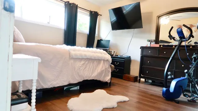 a bed room with a bed tv and a mirror