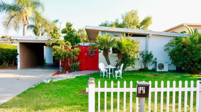 a front view of a house with a yard garage and outdoor seating